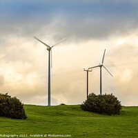 Buy canvas prints of Wind turbines in a green field on the horizon on a cloudy day at sunset by SnapT Photography