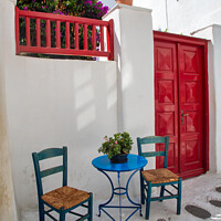 Buy canvas prints of A Table and Two Chairs, Mykonos Town. by Ron Thomas