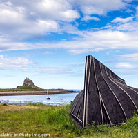 Buy canvas prints of Lindisfarne Castle and boat hut by Jim Monk