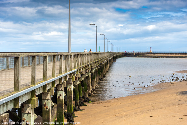 Amble pier and lighthouse Picture Board by Jim Monk