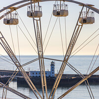 Buy canvas prints of Wheel and Lighthouse, Scarborough by Jim Monk