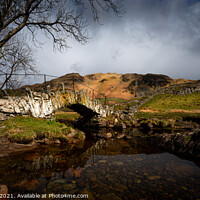 Buy canvas prints of Moody Slaters bridge in the lake district Cumbria between rain and sleet showers.   517  by PHILIP CHALK
