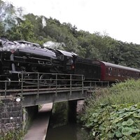 Buy canvas prints of Majestic Steam Train Crossing Canal Bridge by Mark Chesters