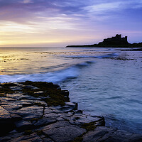 Buy canvas prints of Bamburgh Castle Sunrise  by Anthony McGeever