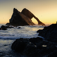 Buy canvas prints of A golden Glow on Bow Fiddle Rock  by Anthony McGeever