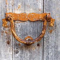 Buy canvas prints of Old door knocker on a wooden door by MallorcaScape Images