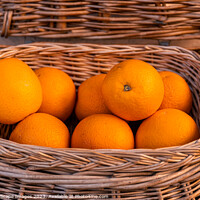 Buy canvas prints of Fresh oranges in a wicker basket by MallorcaScape Images