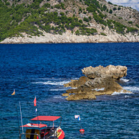 Buy canvas prints of rigid-hulled inflatable boat in Cala Agulla bay in by MallorcaScape Images