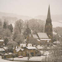 Buy canvas prints of Deer rest in the snowfall admiring the pretty village of Edensor by Sue Lenthall