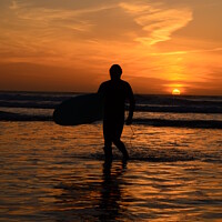 Buy canvas prints of Surfer in a Cornish sunset. by Ed Whiting
