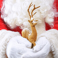 Buy canvas prints of Santa Holding Reindeer Figure by Amanda Elwell