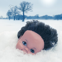 Buy canvas prints of Dolls Head In Snow by Amanda Elwell
