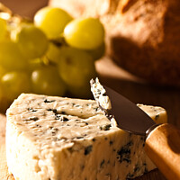 Buy canvas prints of Stilton Cheese With Grapes by Amanda Elwell