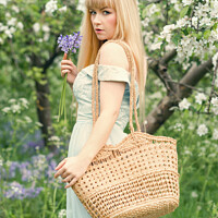 Buy canvas prints of Woman With Basket In Spring Blossom by Amanda Elwell