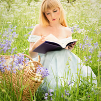 Buy canvas prints of Woman Reading In Spring Meadow by Amanda Elwell