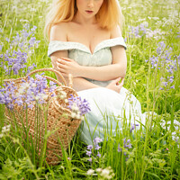 Buy canvas prints of Woman Sitting In Spring Meadow by Amanda Elwell