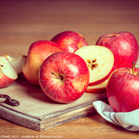 Buy canvas prints of Red Apples On Rustic Chopping Board by Amanda Elwell