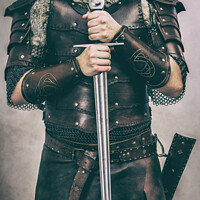 Buy canvas prints of Medieval Cosplay Man With Sword by Amanda Elwell