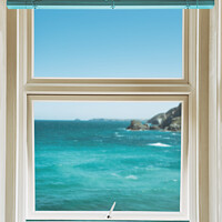 Buy canvas prints of Window Overlooking The Ocean by Amanda Elwell