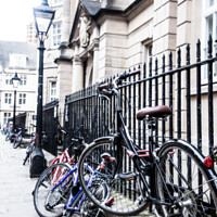 Buy canvas prints of Bikes Chained Up Against Railings Outside Oxford University Coll by Peter Greenway