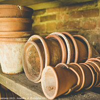 Buy canvas prints of Traditional Terracotta Flower Pots In A Gardeners Shed by Peter Greenway