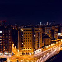 Buy canvas prints of Traffic Light Trails Through Barcelona At Night by Peter Greenway