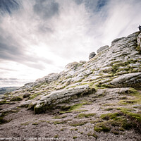 Buy canvas prints of Man Stood Atop Of A Sloping Side Of Haytor Tor, Dartmoor by Peter Greenway