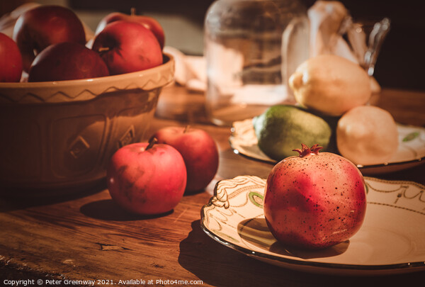 Festive Pomegranate & English Apples On A Rustic Kitchen Table Picture Board by Peter Greenway