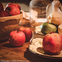 Buy canvas prints of Festive Pomegranate & English Apples On A Rustic Kitchen Table by Peter Greenway