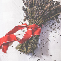 Buy canvas prints of Bunches Of Dried Lavender Tied With A Red Ribbon by Peter Greenway
