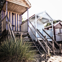 Buy canvas prints of Stilted Beach Huts On The Beach At Wells-next-the-Sea by Peter Greenway