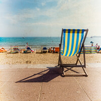 Buy canvas prints of English Seaside Deckchairs On The Sandy Beach & Sea In Swanage by Peter Greenway