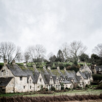 Buy canvas prints of A View Of A Row of Historic Quintessential Cotswold Cottages In Bibury by Peter Greenway