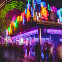 Buy canvas prints of Crowds Wandering Through Heart Stopping Rides At The Annual Street Fair by Peter Greenway