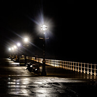 Buy canvas prints of The Promenade Along Whitby Pier At Night by Peter Greenway