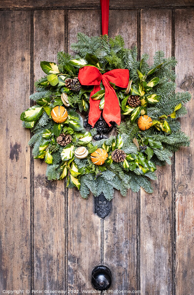 Traditional English Christmas Wreath On A Wooden Farmhouse Door Picture Board by Peter Greenway