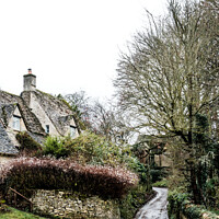 Buy canvas prints of Winding Lane Past Quintessential English Cotswold Cottages In Bi by Peter Greenway
