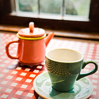 Buy canvas prints of Colourful Teapots & Crockery In A Cotswolds Teashop In Broadway by Peter Greenway