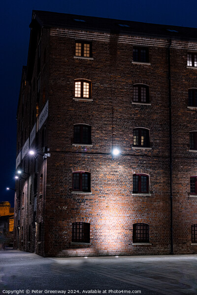 Illuminated Victorian Red Brick Warehouse At The Historic Docks  Picture Board by Peter Greenway