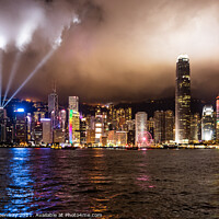 Buy canvas prints of Laser Light Show Over Victoria Harbour At Tsim Sha Tsui, Hong Kong by Peter Greenway