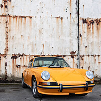 Buy canvas prints of Classic Orange Porsche 911 Outside Rusted Hanger Doors by Peter Greenway