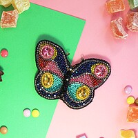 Buy canvas prints of butterfly on colored paper with multicolored sweets by Andrei Babchanok