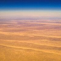 Buy canvas prints of Aerial airplane view of barren Sahara desert landscape in Egypt by Mirko Kuzmanovic
