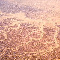 Buy canvas prints of Aerial airplane view of barren Sahara desert landscape in Egypt by Mirko Kuzmanovic
