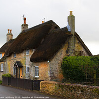 Buy canvas prints of Thatched Cottage in Little Badminton, Cotswolds by Graham Lathbury