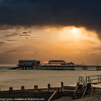 Buy canvas prints of A sunset over Cromer pier in winter by Stuart Chard