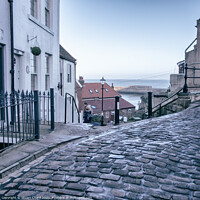 Buy canvas prints of Whitby town cobbled streets and sea view by Stuart Chard