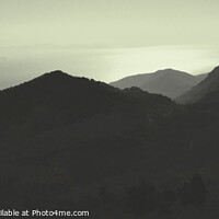 Buy canvas prints of Sunset Over The Mountains Silhouette Of A Mountain Range Against The Sky Panorama by Stuart Chard
