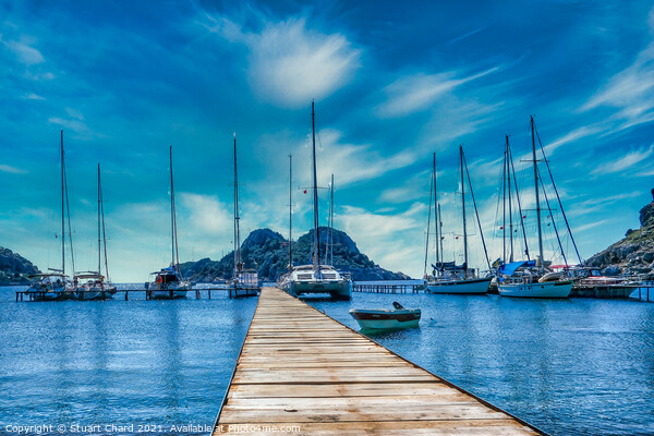 Bay with boats on a jetty artwork Picture Board by Travel and Pixels 