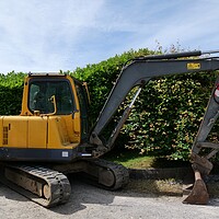 Buy canvas prints of Yellow excavator digger  by Roy Hinchliffe